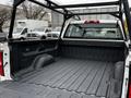 View of the bed of a 2018 GMC Sierra 1500 showing the textured black liner and metal support rack installed in the truck bed