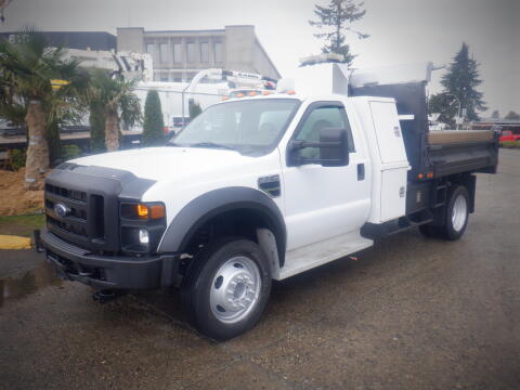 A 2008 Ford F-550 truck with a flatbed in a white color and equipped with a utility body and an automotive tool compartment