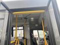 Interior view of a 2016 Chevrolet Express showing the entrance with yellow safety bars and a driver's seat visible in the background