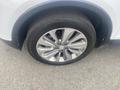 Close-up of a silver alloy wheel with five spokes on a 2018 Buick Encore showing tire tread and brand name on the tire sidewall