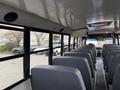 Interior of a 2022 Freightliner B2 school bus featuring several grey seats arranged in rows along the sides