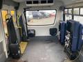 A 2016 Chevrolet Express interior with two rows of seats removed showcasing the vehicle's floor and rear area