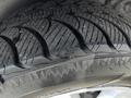 Close-up of a tire tread on a 2011 Dodge Grand Caravan showing detailed patterns and grooves designed for traction