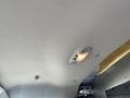 Ceiling interior of a 2012 Chevrolet Express showing a light fixture and a soft fabric surface