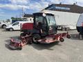 A 2014 Toro Groundmaster 5910 with a black cab and red mowing decks attached on either side parked in a lot