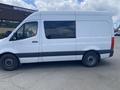 A white 2022 Mercedes-Benz Sprinter van is parked with a high roof and no side windows visible in the foreground