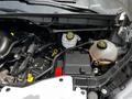 2022 Ford Transit engine compartment showing various components including hoses battery and fluid reservoirs