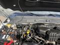 View of the engine compartment of a 2014 Ford F-350 SD showcasing the battery and various hoses and components