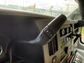 Close-up of the gear shift and controls inside a 2020 Chevrolet Express van showing buttons for gear adjustment