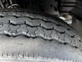 Close-up of a worn tire from a 2009 Ford LCF 550 showing detailed tread patterns and signs of use
