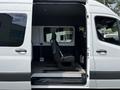 A 2019 Mercedes-Benz Sprinter with an open side door revealing a single driver's seat positioned in the van's interior
