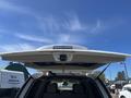 A 2013 Ford Expedition with its rear hatch open, revealing the interior seating and cargo space