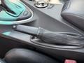 A leather-covered gear shift lever and nearby controls in a 2004 BMW 6-Series interior