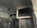 Interior view of a 2009 Peterbilt Highway featuring a storage compartment with a mesh design and integrated shelf along the ceiling