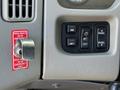 Control panel of a 2008 International 7500 featuring various buttons for mirrors lights and panel controls alongside an emergency valve switch