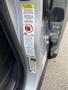 A 2006 Land Rover LR3 showcasing the interior door panel with a warning label and vehicle information sticker