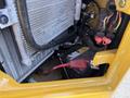 A 2022 Caterpillar 306 with visible components including a radiator battery and wiring harness