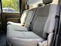 The image shows the rear interior seating of a 2008 Ford F-550 with beige fabric upholstery and seat belts attached to the seats