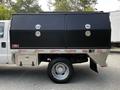 A white 2016 Ford F-550 with black toolboxes mounted on the truck bed featuring two locks and a silver storage compartment at the bottom