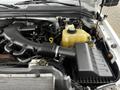 Close-up of the engine compartment of a 2008 Ford F-450 SD showing components like the air intake tube coolant reservoir and various engine parts