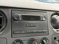 The dashboard controls of a 2008 Ford F-250 SD featuring a radio display including a digital clock and buttons for audio and volume settings