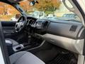 Interior of a 2013 Toyota Tacoma showing the dashboard controls seats and floor mats
