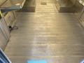 The interior of a 2012 Ford Econoline with a flat metal floor and ramp on one side designed for accessibility