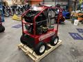 A red 2024 Magnum 4000 Hot Water Pressure Washer on a wooden pallet featuring large wheels a black engine and multiple control panels