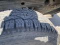 Close-up of a rugged tire on a 2014 GMC Sierra 1500 showcasing deep treads designed for traction and durability