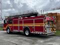 A red 2009 Spartan Gladiator fire truck with multiple compartments and a raised ladder on top