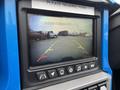 A rearview camera display showing guidelines for parking with yellow and red markers on a monitor inside a 2020 Polaris SlingShot