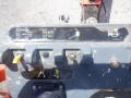 Control panel of a 2008 JLG Boom Lift featuring levers and icons indicating operational functions