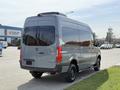 A 2019 Mercedes-Benz Sprinter van in gray with tinted windows and a high roof viewed from the rear angle