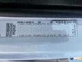 2004 Freightliner M2 with a detailed tire specifications label including axle information tire sizes and pressure ratings