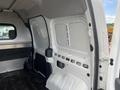 Interior view of a 2010 Ford Transit Connect showing cargo space with metal panels and black flooring