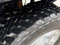Close-up of a wet tire tread on a 2016 Ford F-350 SD showing deep grooves and rugged design for off-road traction