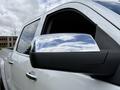 A 2017 Chevrolet Silverado 1500 with a shiny chrome mirror and a sleek side profile