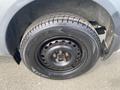 A close-up view of a 2013 Ford Transit Connect wheel featuring a black steel rim and a Michelin tire with visible tread pattern