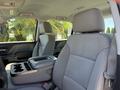 Interior view of a 2016 GMC Sierra 1500 featuring gray fabric seats and a center console with storage compartments