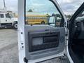 The image shows the open driver's side door of a 2015 Ford F-250 SD with a gray door panel featuring a handle and storage compartment