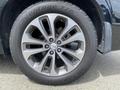 Close-up of a 2015 Kia Sorento alloy wheel with a black tire showing the brand name and tread pattern