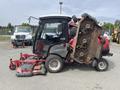 A 2012 Toro Groundsmaster 5910 with its mower deck elevated showing the cutting blades and engine compartment