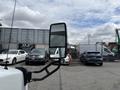 Side mirror of a 2020 Chevrolet Express with a view of vehicles in the background