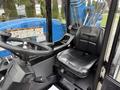 A 2020 Genie GTH-5519 telehandler with a black leather seat and control panel featuring levers and warning labels