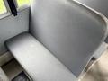 A grey vinyl seat from a 2013 International 3000 school bus