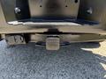 A black hitch receiver mounted on the rear of a 2014 Ford F-250 SD truck