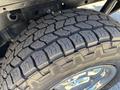 Close-up of a rugged tire tread on a 2016 Ford F-150 showing deep grooves and a robust design meant for off-road driving