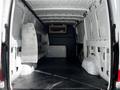 Interior view of a 2020 Mercedes-Benz Sprinter van showing empty cargo space with metal shelving units installed on one side