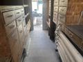 Interior view of a 2007 Morgan Olson Workhorse W42 showing wooden cabinets and drawers lining both sides of a narrow aisle