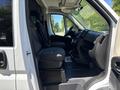 Interior of a 2016 RAM Promaster showing two front seats and the driver's cockpit with controls and dashboard details visible